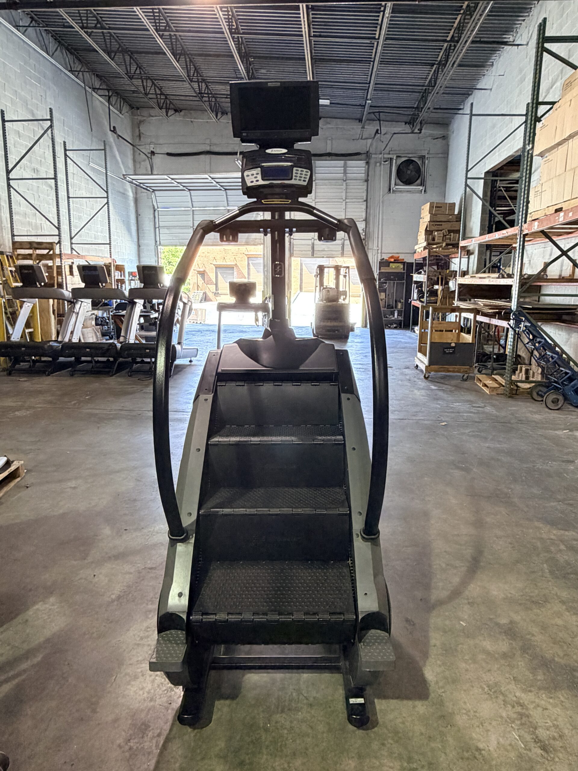 StairMaster Gauntlet Stepmill with LCD D-1 Console and integrated TV screen available for sale at Innovative Fitness in Kennesaw, Georgia, featuring commercial-grade stair climbing performance.